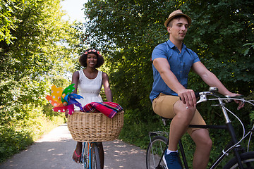 Image showing Young multiethnic couple having a bike ride in nature