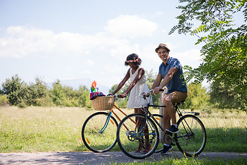 Image showing Young multiethnic couple having a bike ride in nature