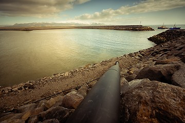 Image showing Sewage pipe running into bay