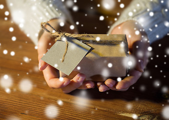 Image showing close up of woman with christmas gift or parcel