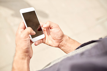 Image showing close up of man with smartphone on street