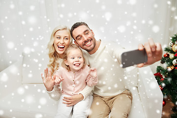 Image showing family taking selfie with smartphone at christmas