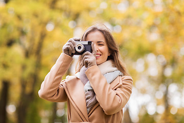 Image showing woman photographing with camera in autumn park