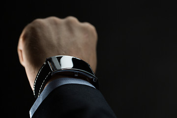 Image showing close up of businessman hand with smart watch