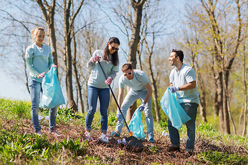 Image showing volunteers with garbage bags cleaning park area