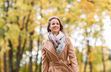 Image showing beautiful happy young woman walking in autumn park