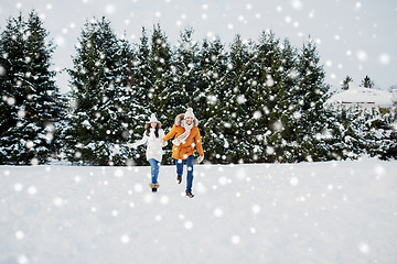 Image showing happy couple running in winter snow