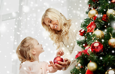 Image showing happy family decorating christmas tree at home