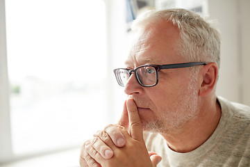 Image showing close up of senior man in glasses thinking