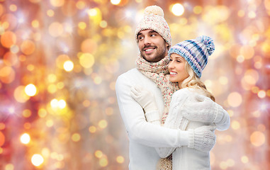 Image showing smiling couple in winter clothes hugging