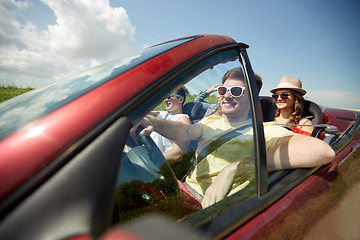 Image showing happy friends driving in cabriolet car