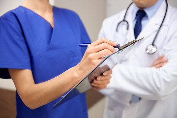 Image showing close up of doctors with clipboard at hospital