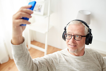 Image showing senior man with smartphone and headphones