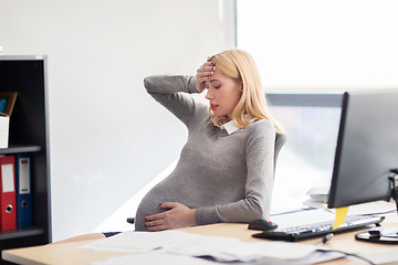 Image showing pregnant businesswoman feeling sick at office work