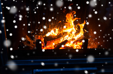 Image showing close up of firewood burning in fireplace and snow