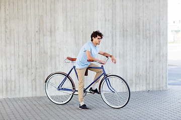 Image showing young hipster man riding fixed gear bike