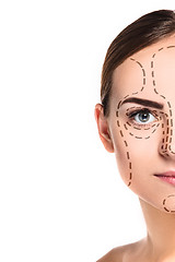 Image showing The beautiful woman face with arrows close up over white background