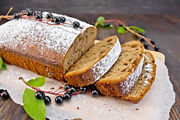 Image showing Fruitcake bird cherry cut with berries on board