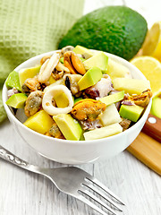 Image showing Salad with seafood and avocado in bowl on white board