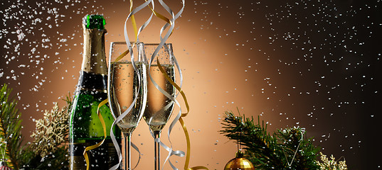 Image showing Holiday champagne on background of fir-tree branches with toys