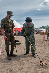 Image showing Man - visitor of show tries on the sapper suit