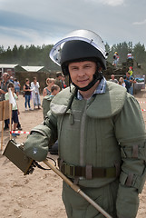 Image showing Man - visitor of show tries on the sapper suit