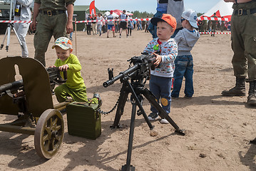 Image showing The boy considers an easel machine gun