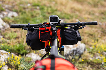 Image showing Bicycle with orange bags for travel