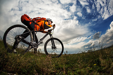 Image showing Young man is riding bicycle outside. Healthy Lifestyle.