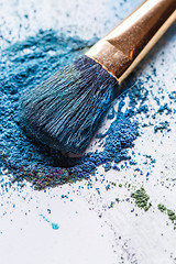 Image showing Eyeshadow with brush scattered on white background