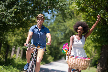 Image showing Young multiethnic couple having a bike ride in nature