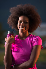 Image showing Portrait of a young african american woman running outdoors