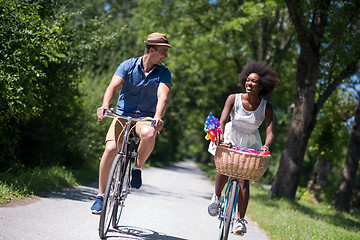 Image showing Young multiethnic couple having a bike ride in nature