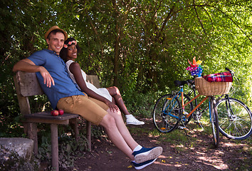 Image showing Young multiethnic couple having a bike ride in nature