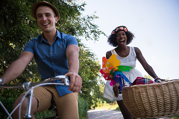 Image showing Young multiethnic couple having a bike ride in nature