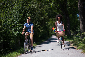 Image showing Young multiethnic couple having a bike ride in nature