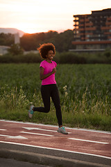 Image showing a young African American woman jogging outdoors