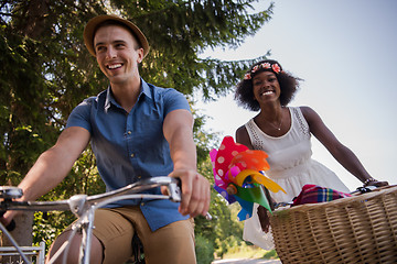 Image showing Young multiethnic couple having a bike ride in nature