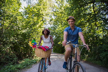 Image showing Young multiethnic couple having a bike ride in nature