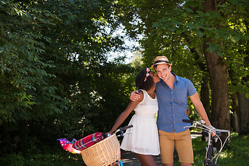 Image showing Young multiethnic couple having a bike ride in nature