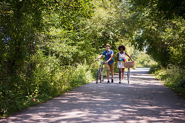 Image showing Young multiethnic couple having a bike ride in nature