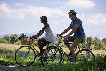 Image showing Young multiethnic couple having a bike ride in nature