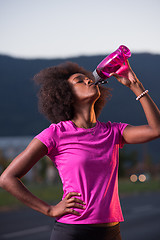 Image showing Portrait of a young african american woman running outdoors