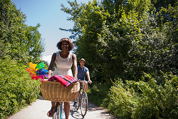 Image showing Young multiethnic couple having a bike ride in nature