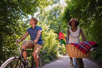 Image showing Young multiethnic couple having a bike ride in nature