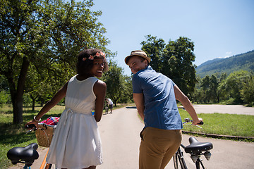 Image showing Young multiethnic couple having a bike ride in nature