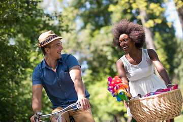 Image showing Young multiethnic couple having a bike ride in nature