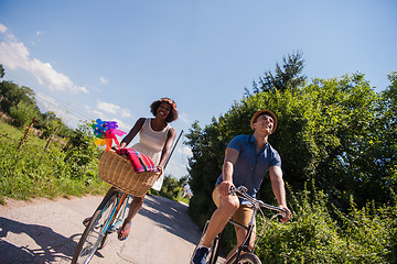 Image showing Young multiethnic couple having a bike ride in nature