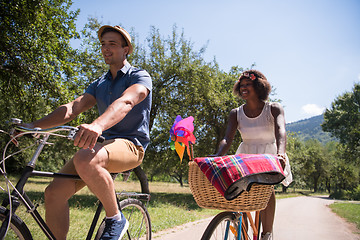 Image showing Young multiethnic couple having a bike ride in nature