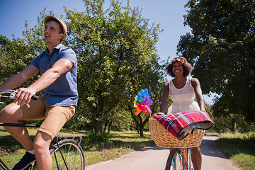 Image showing Young multiethnic couple having a bike ride in nature